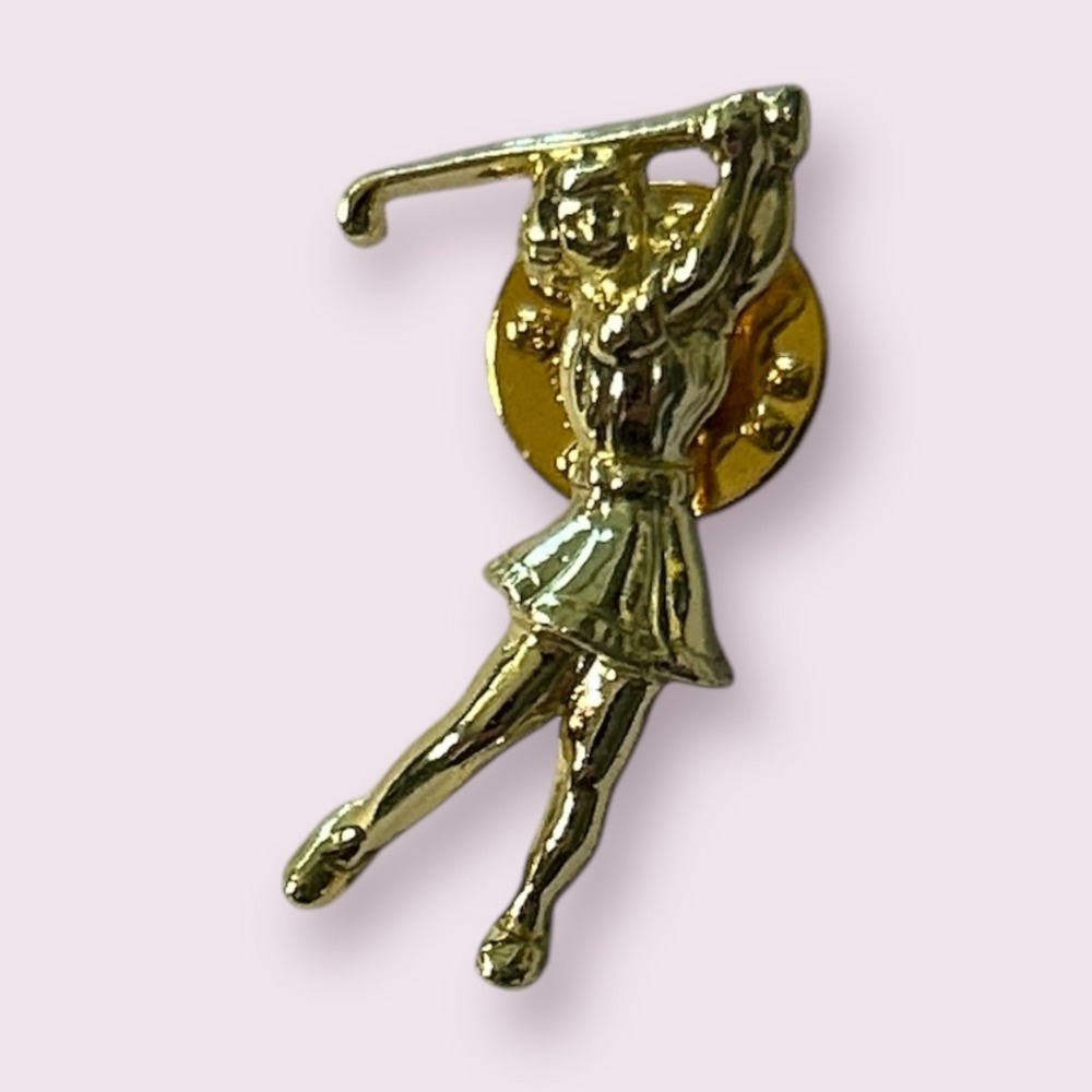 Goldtone woman in‎ skirt golfing pin